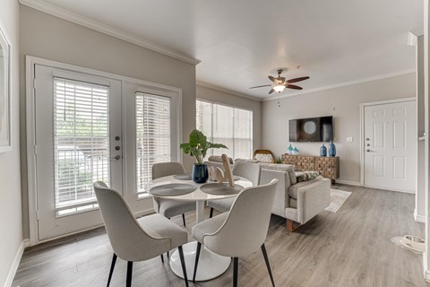 A dining room with a table and chairs.